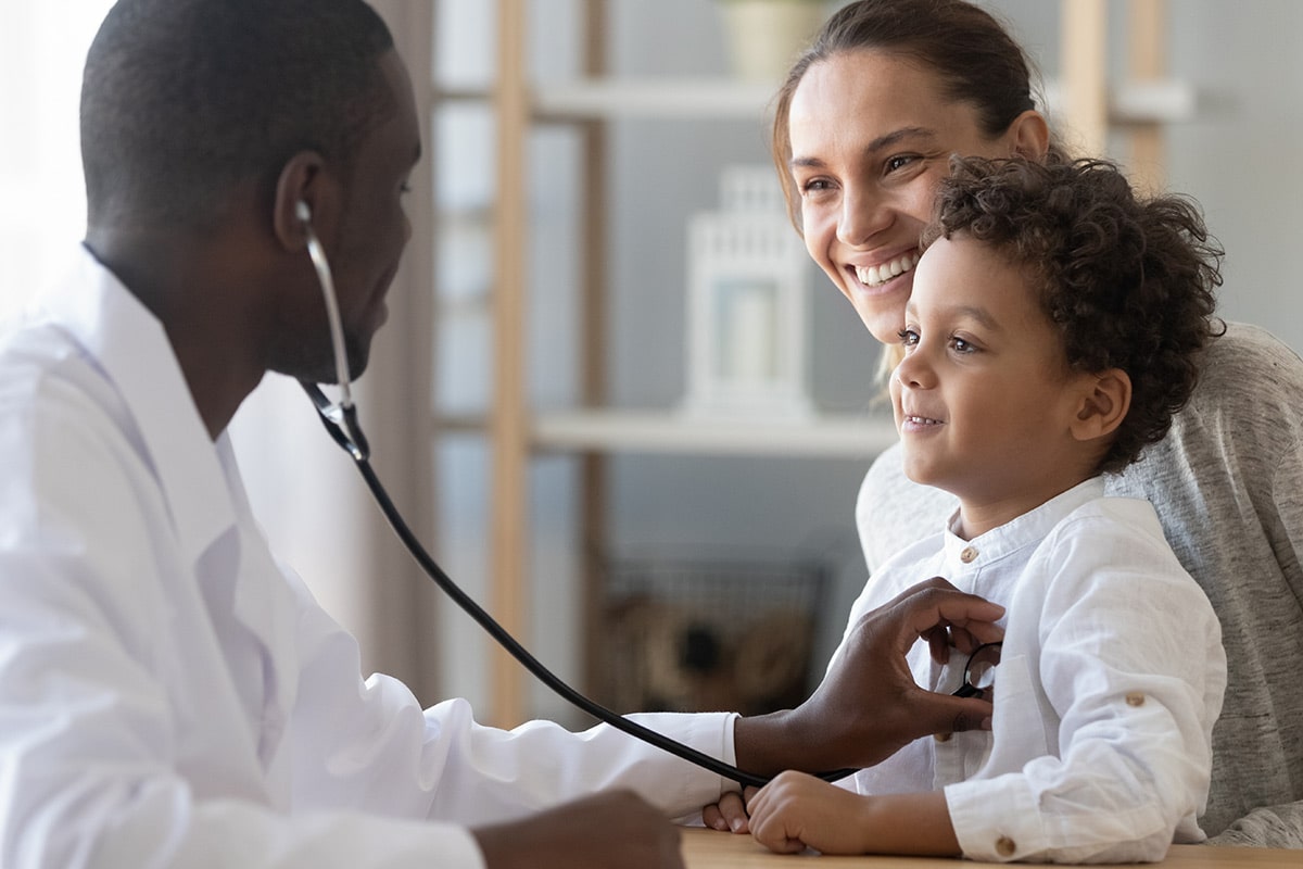 Doctor using stethoscope on toddler
