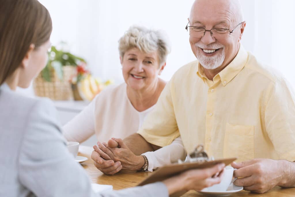 Older couple talking to insurance agent